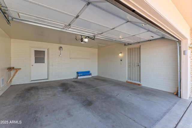 garage featuring visible vents and a garage door opener