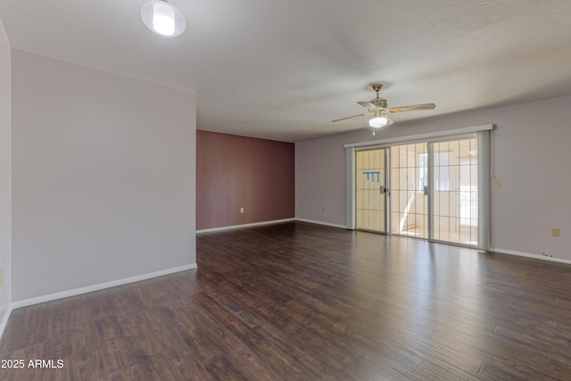 unfurnished room featuring ceiling fan, baseboards, and dark wood-type flooring
