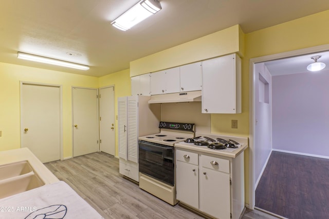 kitchen with light countertops, white electric range, white cabinetry, light wood-type flooring, and under cabinet range hood