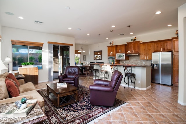 living room featuring recessed lighting, light tile patterned flooring, and visible vents