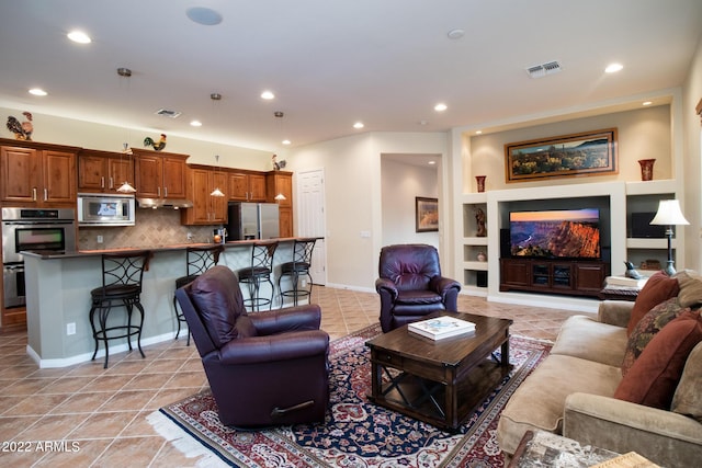 living area with visible vents, recessed lighting, built in features, and light tile patterned floors