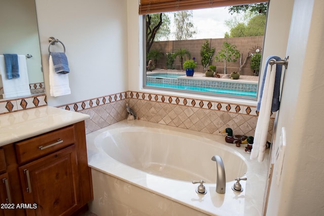 bathroom with vanity and a bath