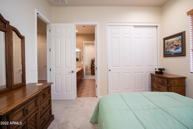 bedroom featuring light carpet, a closet, and visible vents
