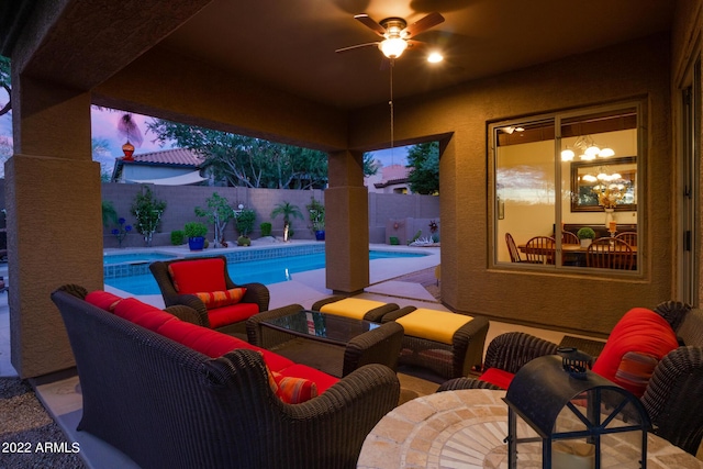 view of patio / terrace with a fenced in pool, a ceiling fan, an outdoor living space, and a fenced backyard