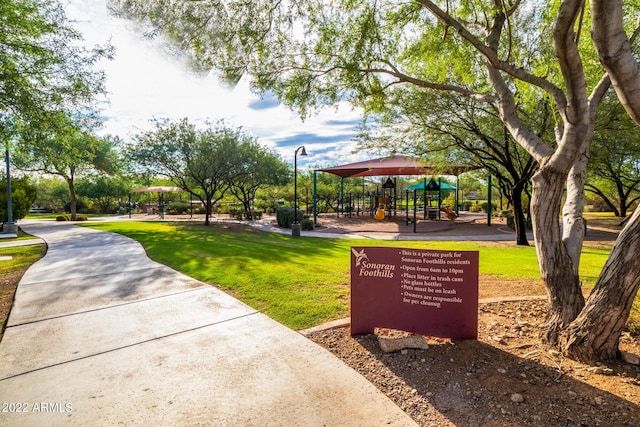 view of community with a lawn and playground community