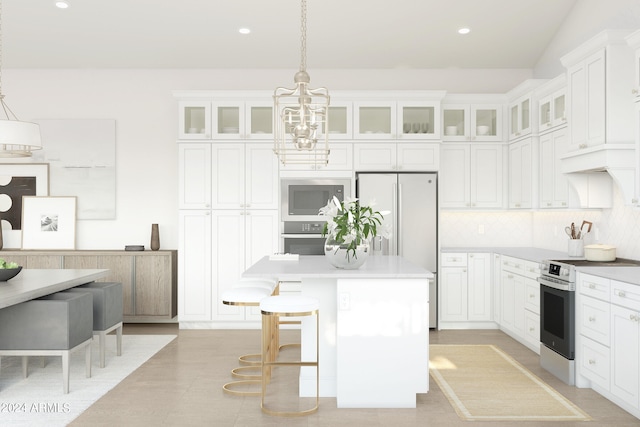 kitchen featuring white cabinets, decorative backsplash, decorative light fixtures, a kitchen island, and stainless steel appliances