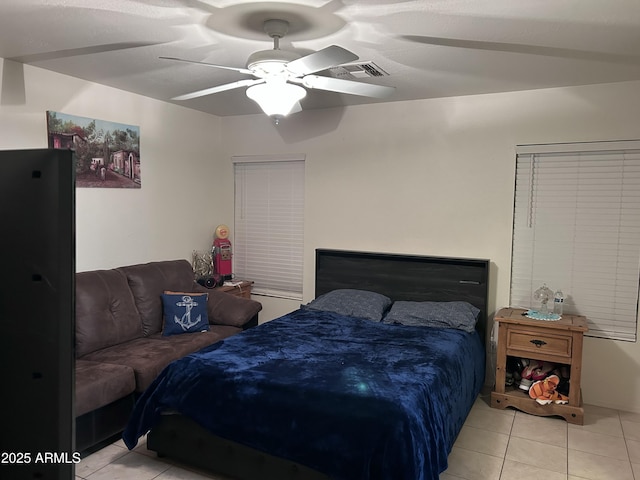 bedroom featuring light tile patterned floors and ceiling fan