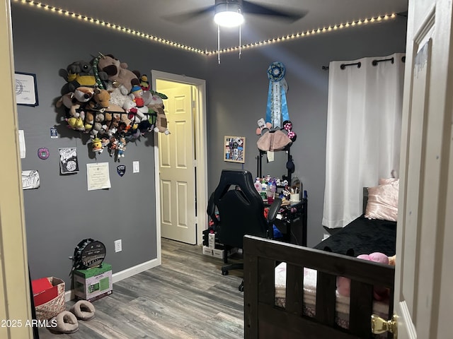 bedroom with wood-type flooring and ceiling fan