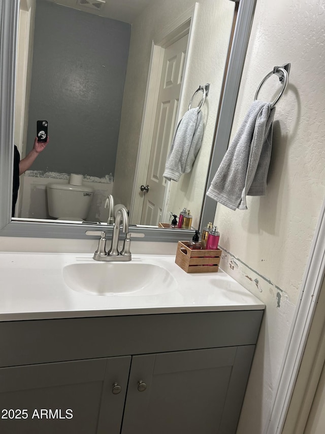 bathroom with vanity and toilet