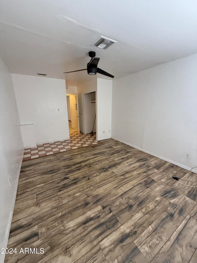 unfurnished bedroom with ceiling fan and dark hardwood / wood-style flooring