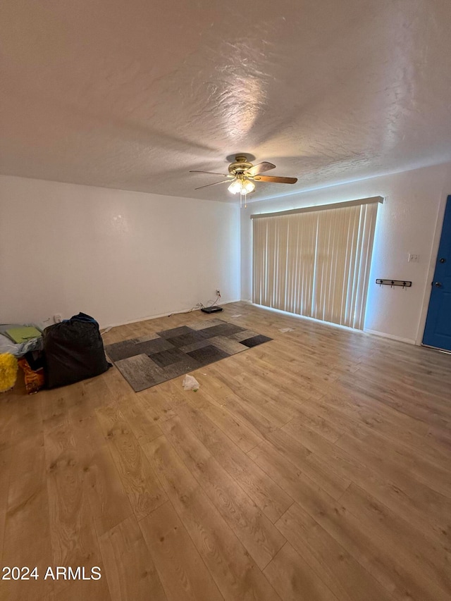 unfurnished room featuring ceiling fan, a textured ceiling, and hardwood / wood-style floors