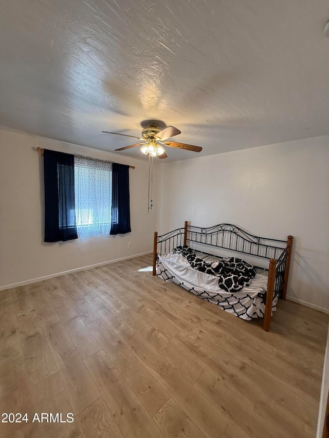 bedroom with wood-type flooring and ceiling fan