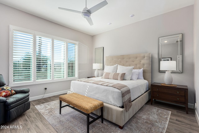 bedroom with ceiling fan and dark hardwood / wood-style floors