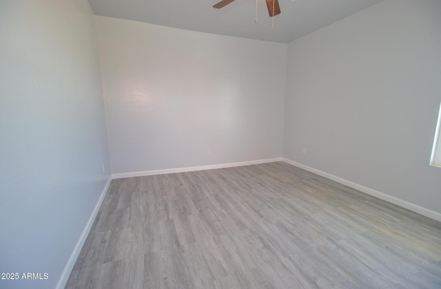 empty room featuring a ceiling fan, wood finished floors, and baseboards