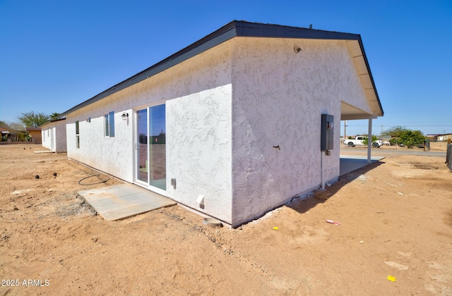 view of side of home featuring stucco siding