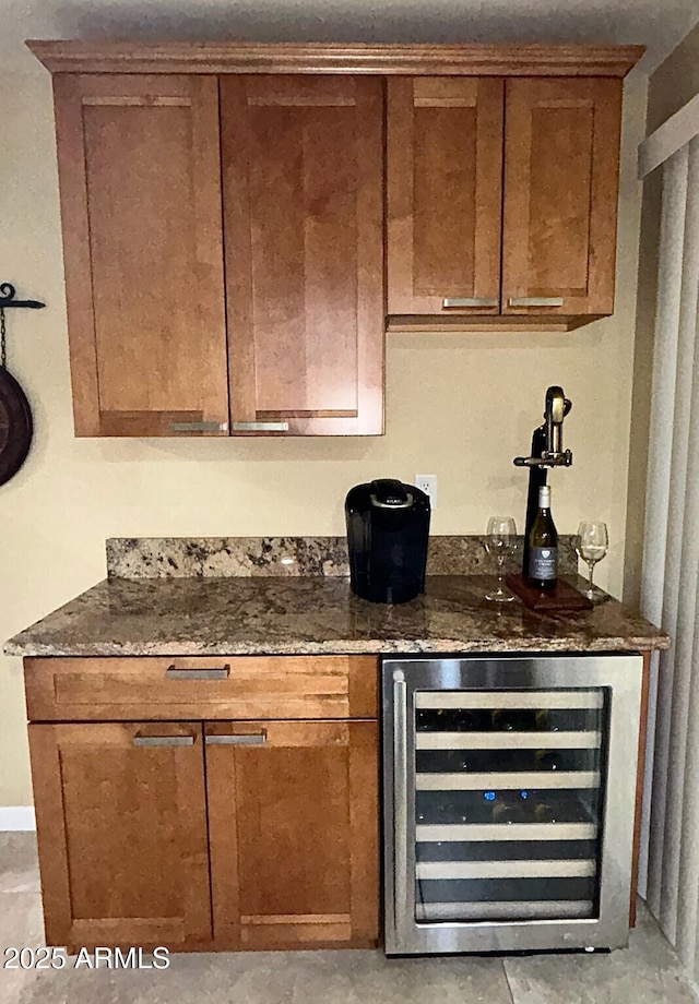 bar with beverage cooler and dark stone counters