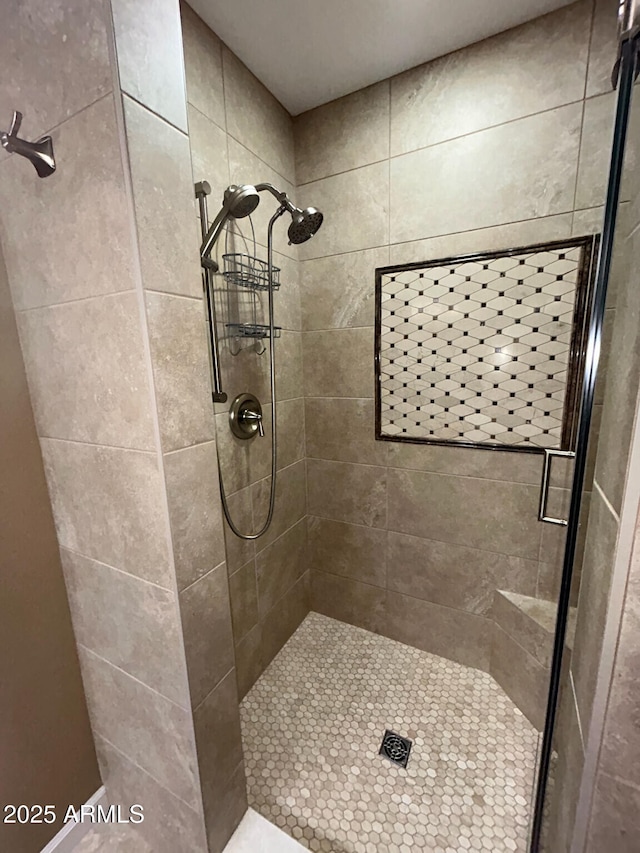 bathroom with tiled shower