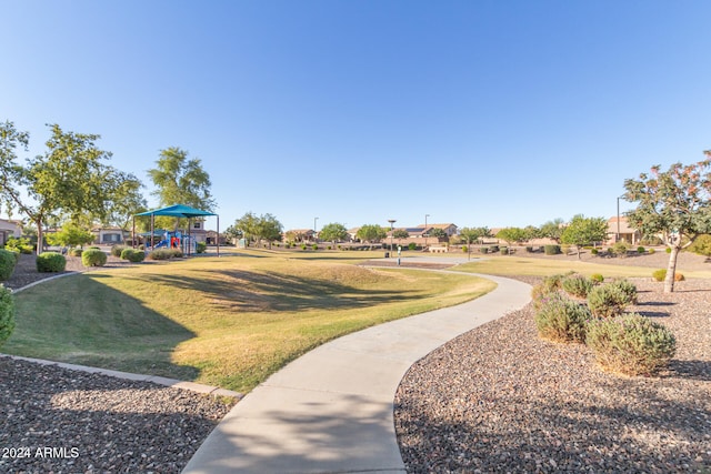 view of property's community featuring a lawn and a playground