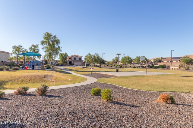 view of home's community with a playground and a lawn