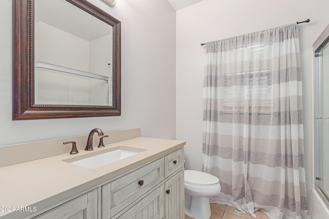 bathroom featuring vanity, tile patterned flooring, and toilet