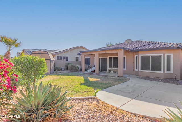 back of property featuring a yard and a patio area