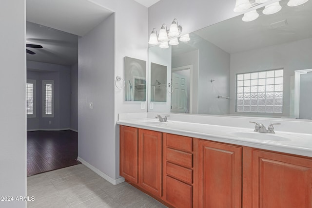 bathroom with wood-type flooring, ceiling fan, and vanity