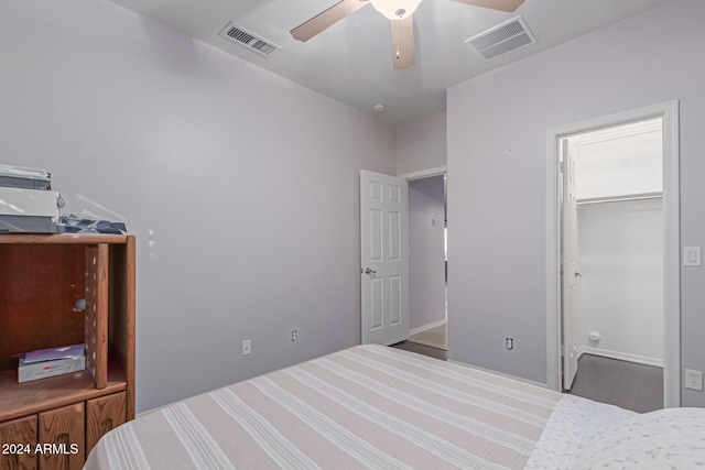 bedroom with a spacious closet, ceiling fan, and a closet