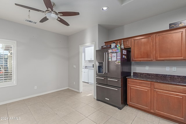 kitchen with dark stone counters, ceiling fan, high quality fridge, and light tile patterned flooring