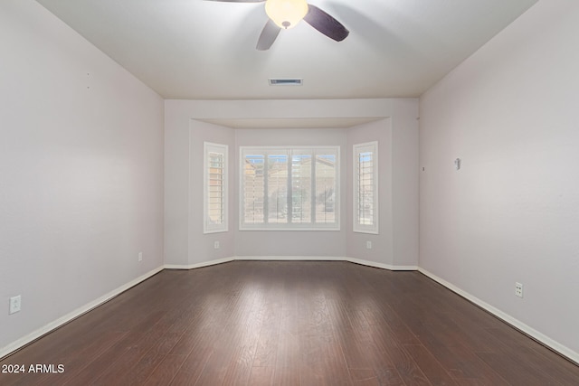 spare room featuring dark hardwood / wood-style floors and ceiling fan