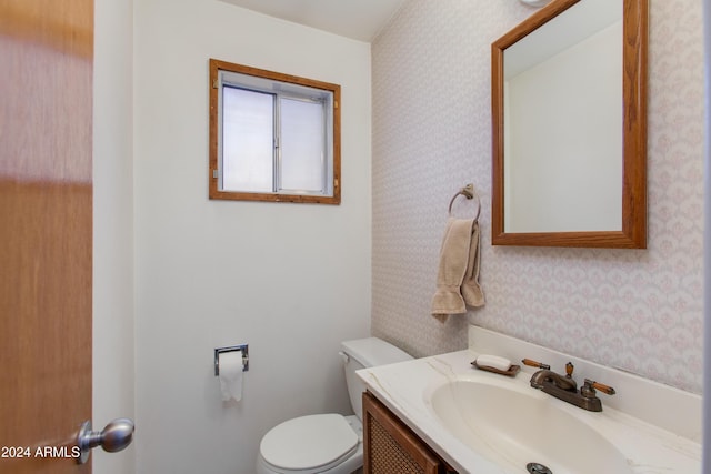 bathroom featuring vanity and toilet