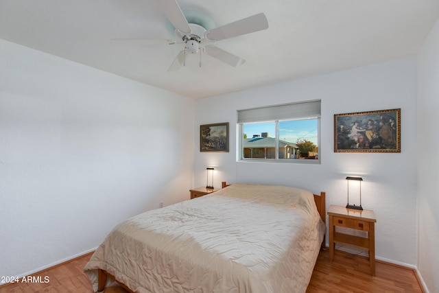 bedroom with wood-type flooring and ceiling fan