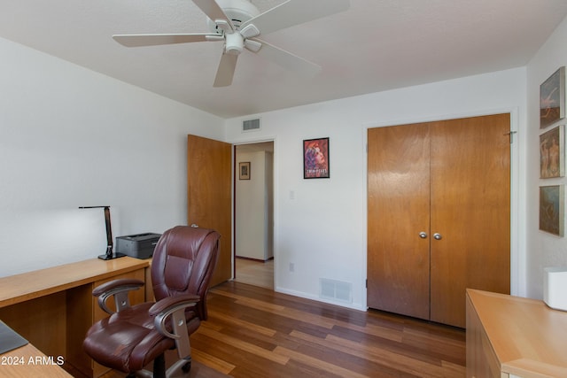 home office with dark wood-type flooring and ceiling fan