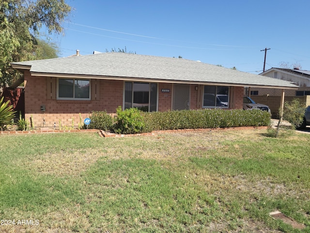 ranch-style home featuring a front yard