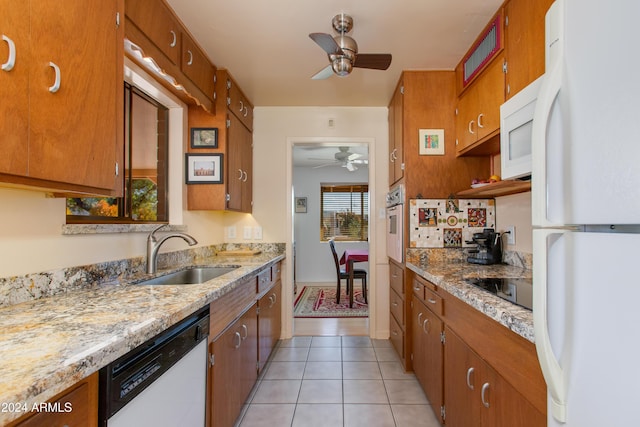 kitchen featuring sink, white appliances, light stone countertops, and ceiling fan