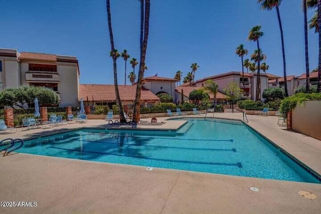 pool featuring a patio and fence