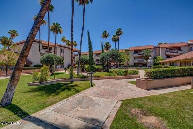 view of home's community featuring a lawn