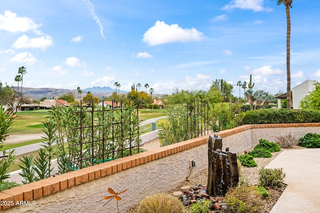 view of home's community with a mountain view and fence