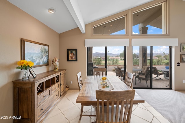 dining space with light tile patterned floors, beamed ceiling, high vaulted ceiling, and a healthy amount of sunlight