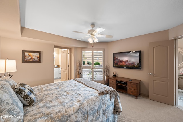 bedroom with ensuite bath, access to outside, light colored carpet, and ceiling fan