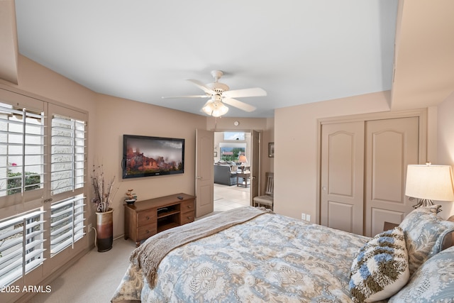 bedroom featuring a ceiling fan, carpet, and a closet