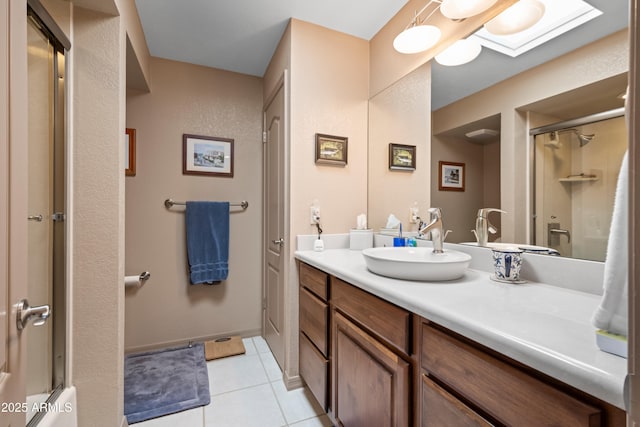 full bathroom featuring vanity, tile patterned floors, and baseboards