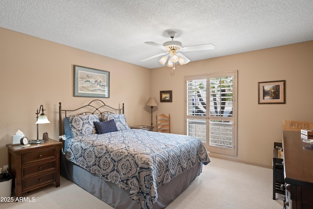 bedroom featuring light carpet, a textured ceiling, and a ceiling fan