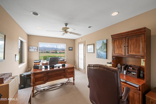 office space featuring recessed lighting, light carpet, and a ceiling fan