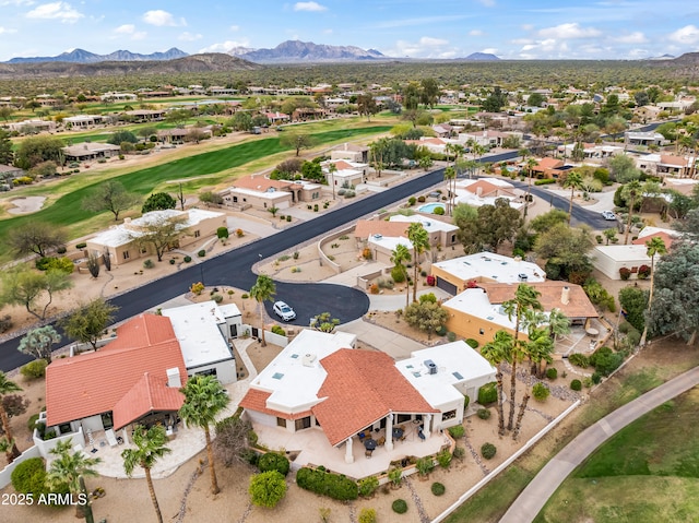 bird's eye view featuring golf course view, a mountain view, and a residential view