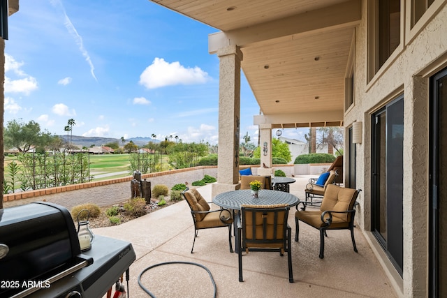 view of patio with outdoor dining area and a mountain view