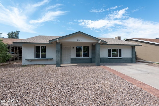 3741 W Poinsettia Dr, Phoenix, AZ 85029 - ranch-style house with covered porch, driveway, roof with shingles, and brick siding