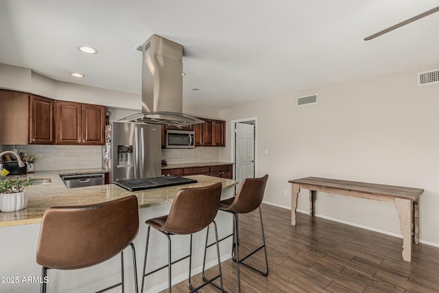 3741 W Poinsettia Dr, Phoenix, AZ 85029 - kitchen with stainless steel appliances, a sink, island range hood, a kitchen bar, and backsplash