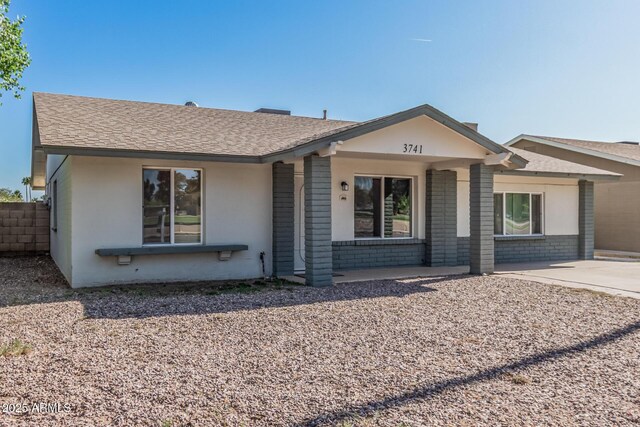 3741 W Poinsettia Dr, Phoenix, AZ 85029 - ranch-style home with covered porch, roof with shingles, brick siding, driveway, and stucco siding