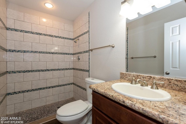 3741 W Poinsettia Dr, Phoenix, AZ 85029 - full bathroom with vanity, toilet, a tile shower, and a textured wall