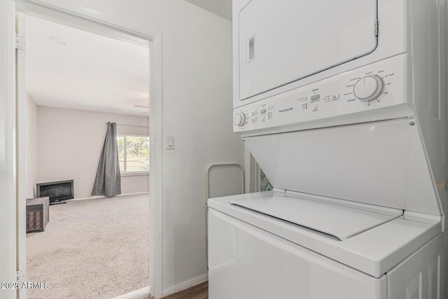 3741 W Poinsettia Dr, Phoenix, AZ 85029 - laundry area featuring stacked washer and clothes dryer, carpet, and baseboards